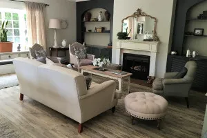 Cozy living room with sofa armchairs fireplace and decorative elements