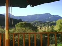 Wooden balcony with mountain view under a blue sky