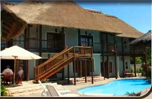 Thatchedroof house with pool outdoor seating and staircase