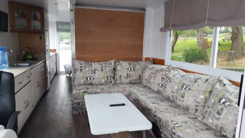 Cozy interior with a patterned sofa table and large windows showing greenery outside