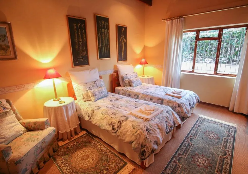 Cozy bedroom with two twin beds floral bedding and warm lighting