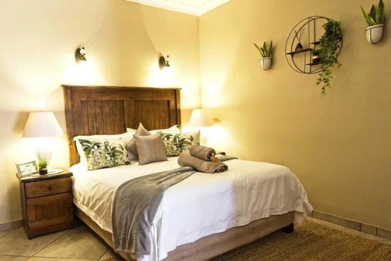 Cozy bedroom with a large bed wooden headboard and bedside lamps