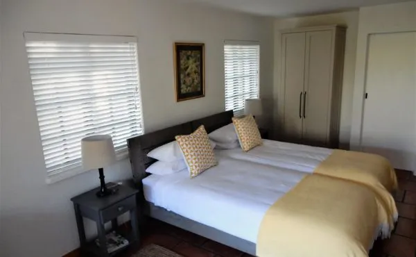 Bedroom with two single beds nightstand lamp and wardrobe