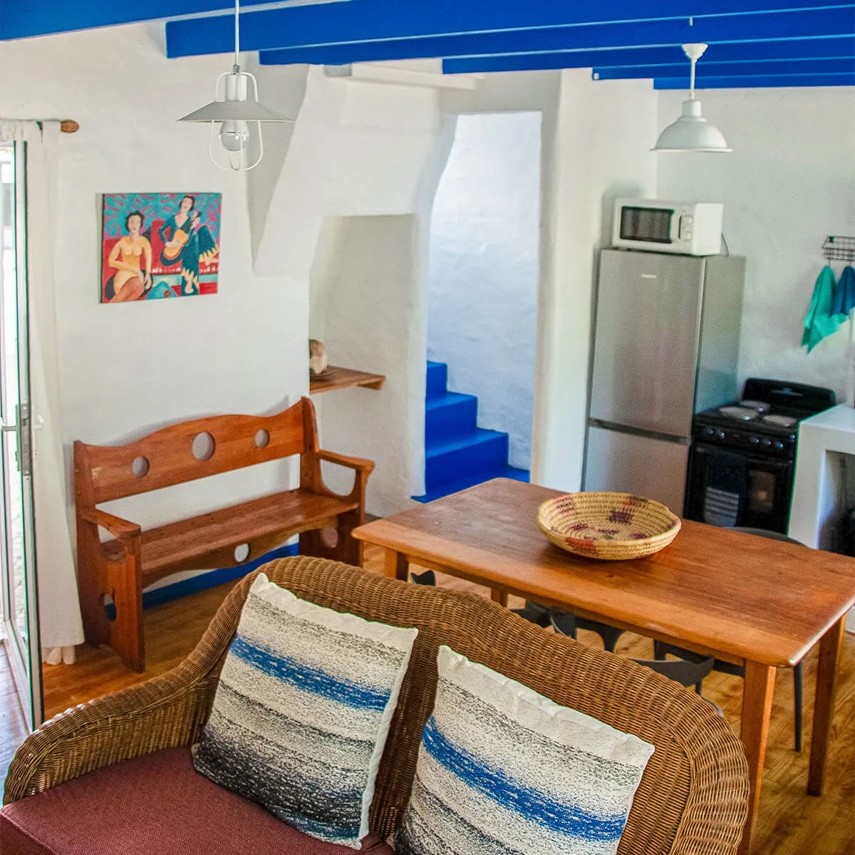 Cozy kitchen with wooden furniture colorful ceiling and appliances in a small room