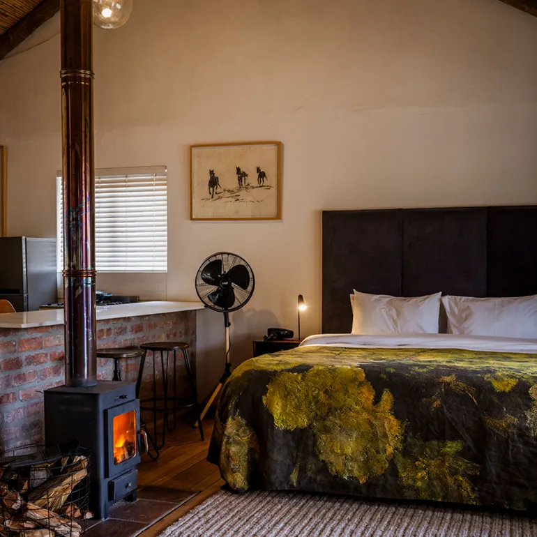 Cozy bedroom with a fireplace bed and rustic decor