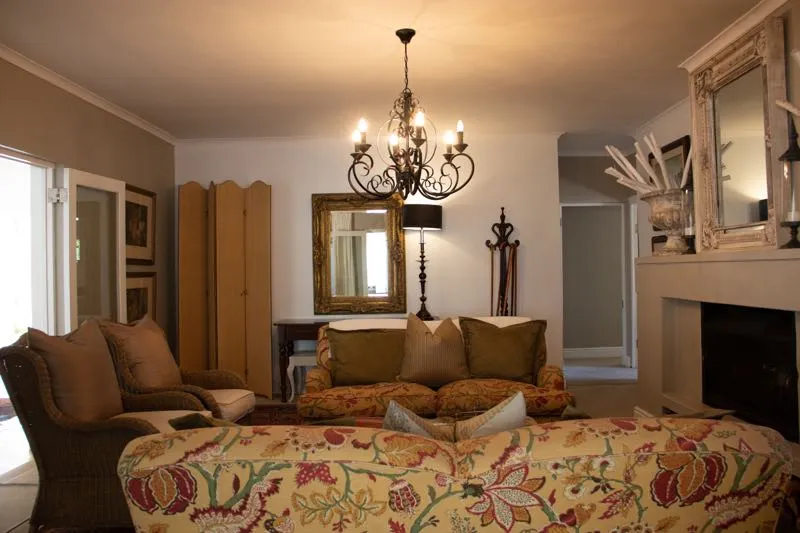 Cozy living room with floral sofa armchairs and chandelier