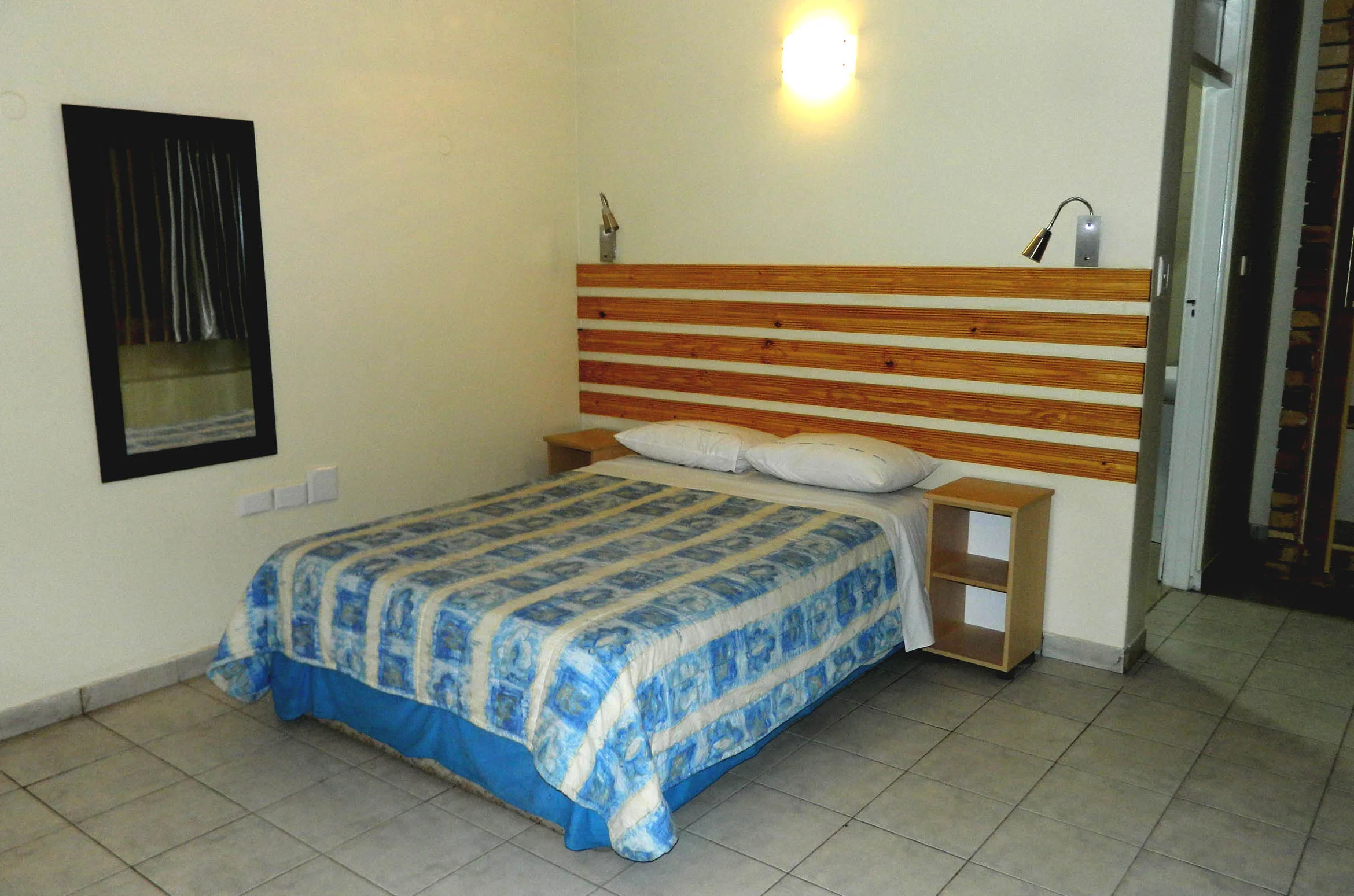 Bedroom with a double bed wooden headboard and bedside tables