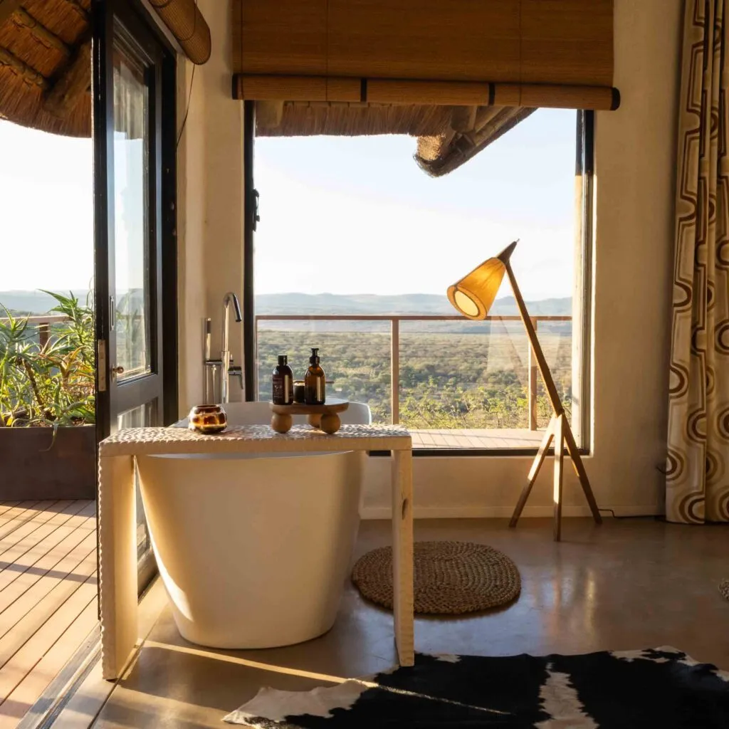 Modern bathroom with large window bathtub and scenic outdoor view