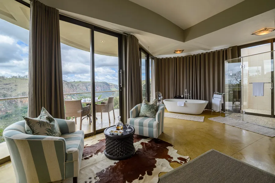 Modern living room with large windows bathtub and outdoor view