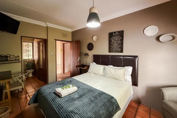 Cozy bedroom with a bed lamp and wall decorations tiled floor