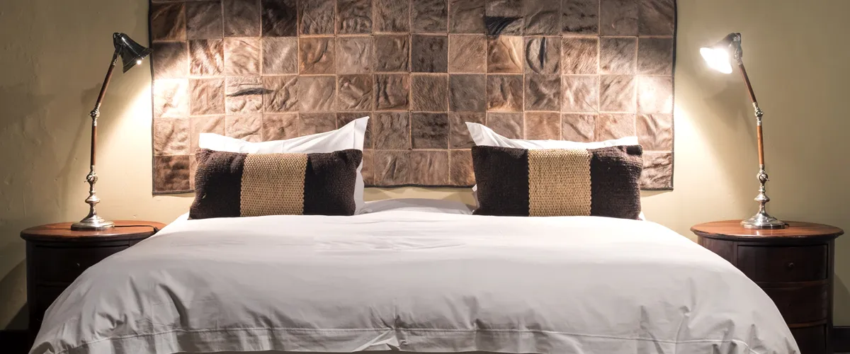 Cozy bedroom with a neatly made bed two pillows and bedside lamps