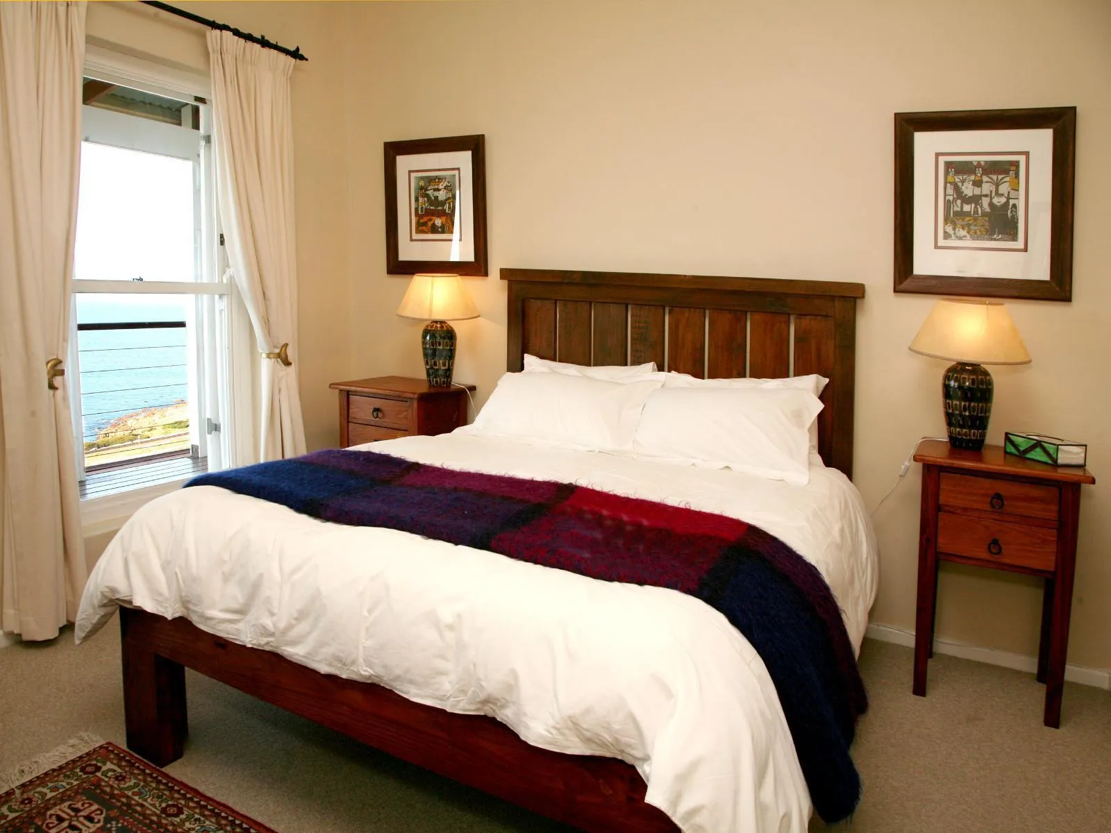 Cozy bedroom with a large bed ocean view and warm lighting