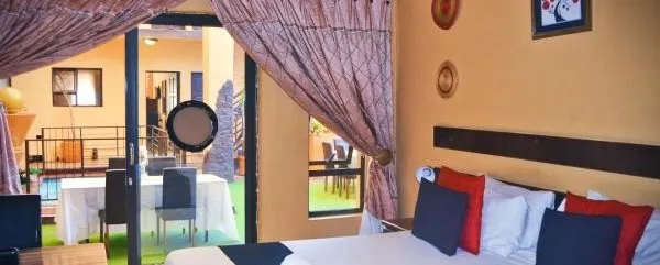 Bedroom with a large bed sliding door and view of an outdoor dining area