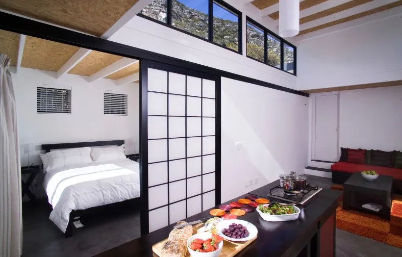 Modern studio apartment with bed kitchen area and food on counter