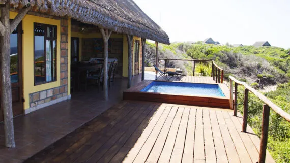 Beachfront house with wooden deck plunge pool and ocean view
