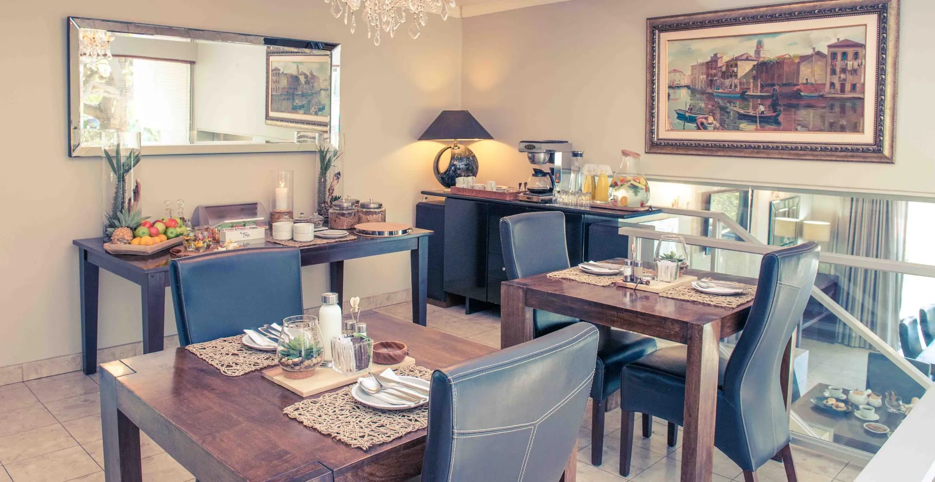 Dining area with tables chairs and wall art in a cozy room