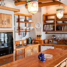 Cozy kitchen with wooden cabinets colorful lanterns and modern appliances