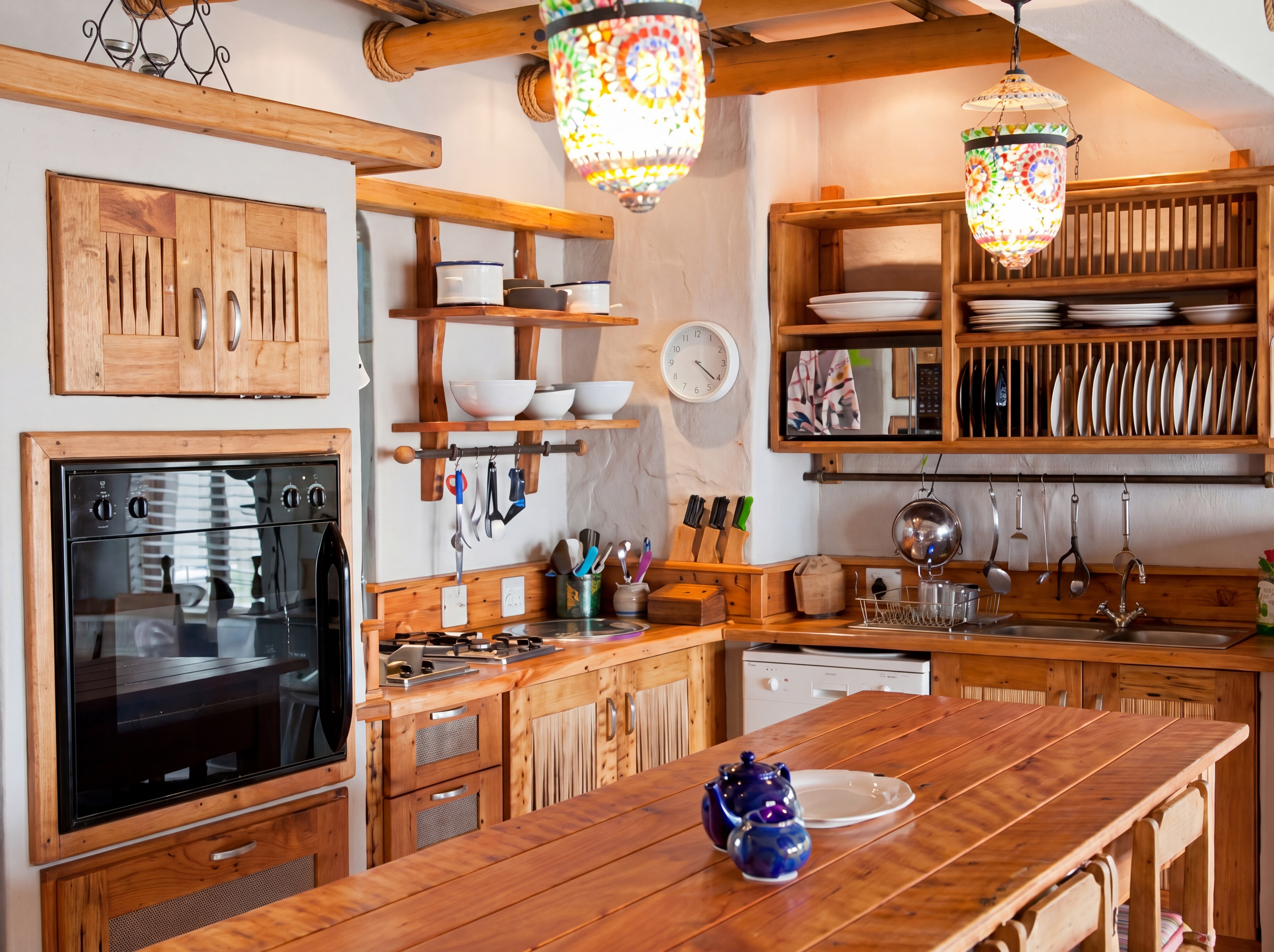 Cozy kitchen with wooden cabinets colorful lanterns and modern appliances