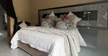 Cozy bedroom with neatly made bed decorative pillows and modern headboard