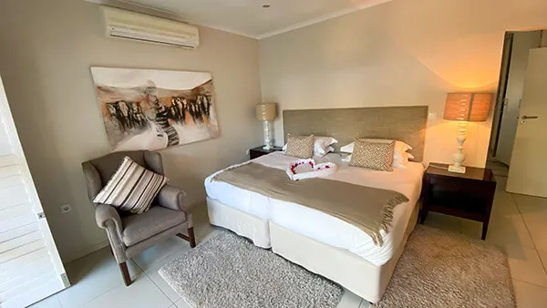 Cozy bedroom with a large bed armchair and bedside lamps