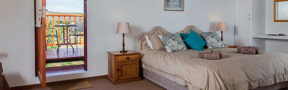 Cozy bedroom with a large bed bedside tables lamps and an open door