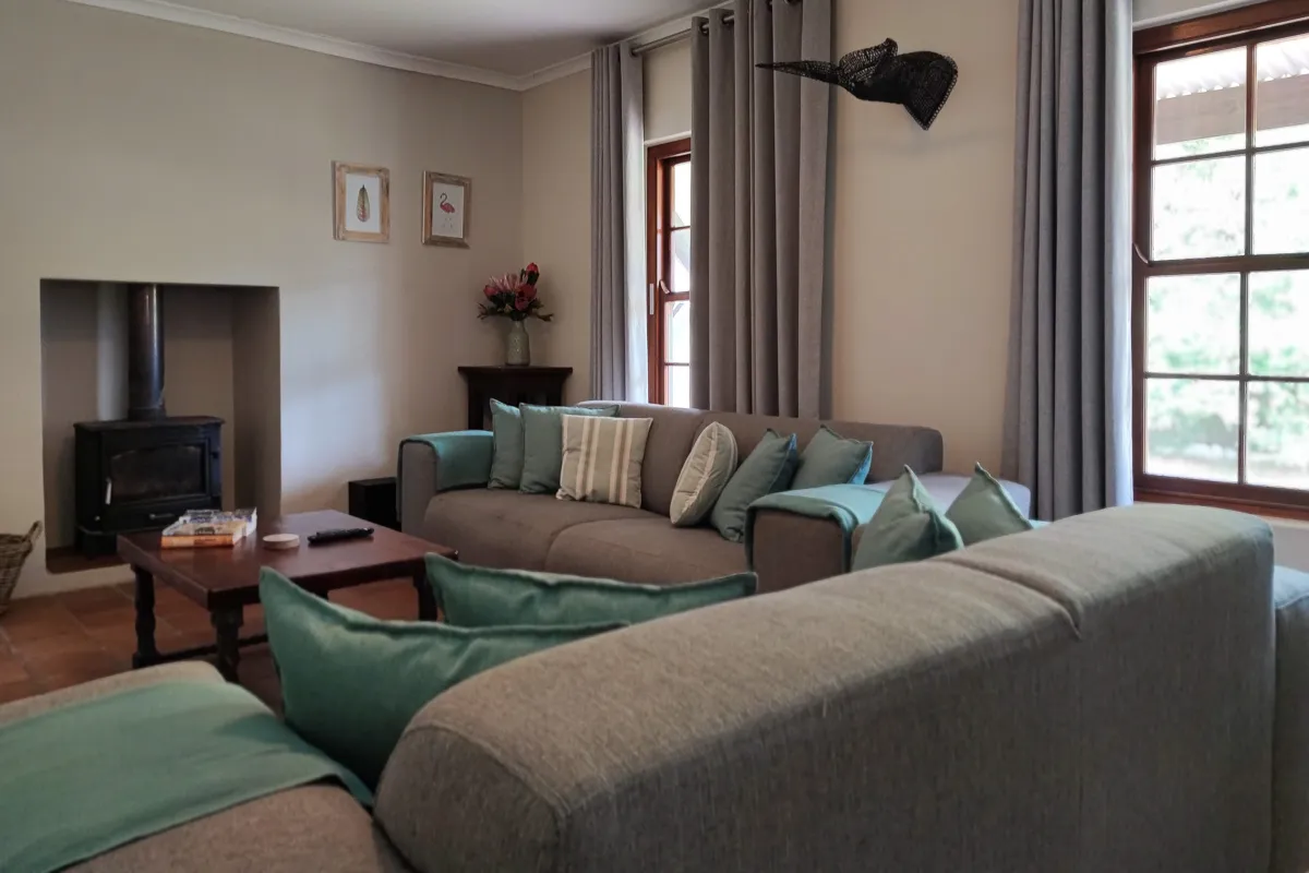 Cozy living room with grey sofas fireplace and large windows