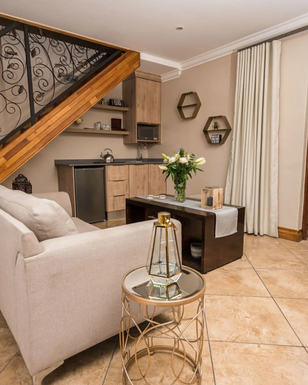 Modern living room with sofa coffee table and staircase in the background