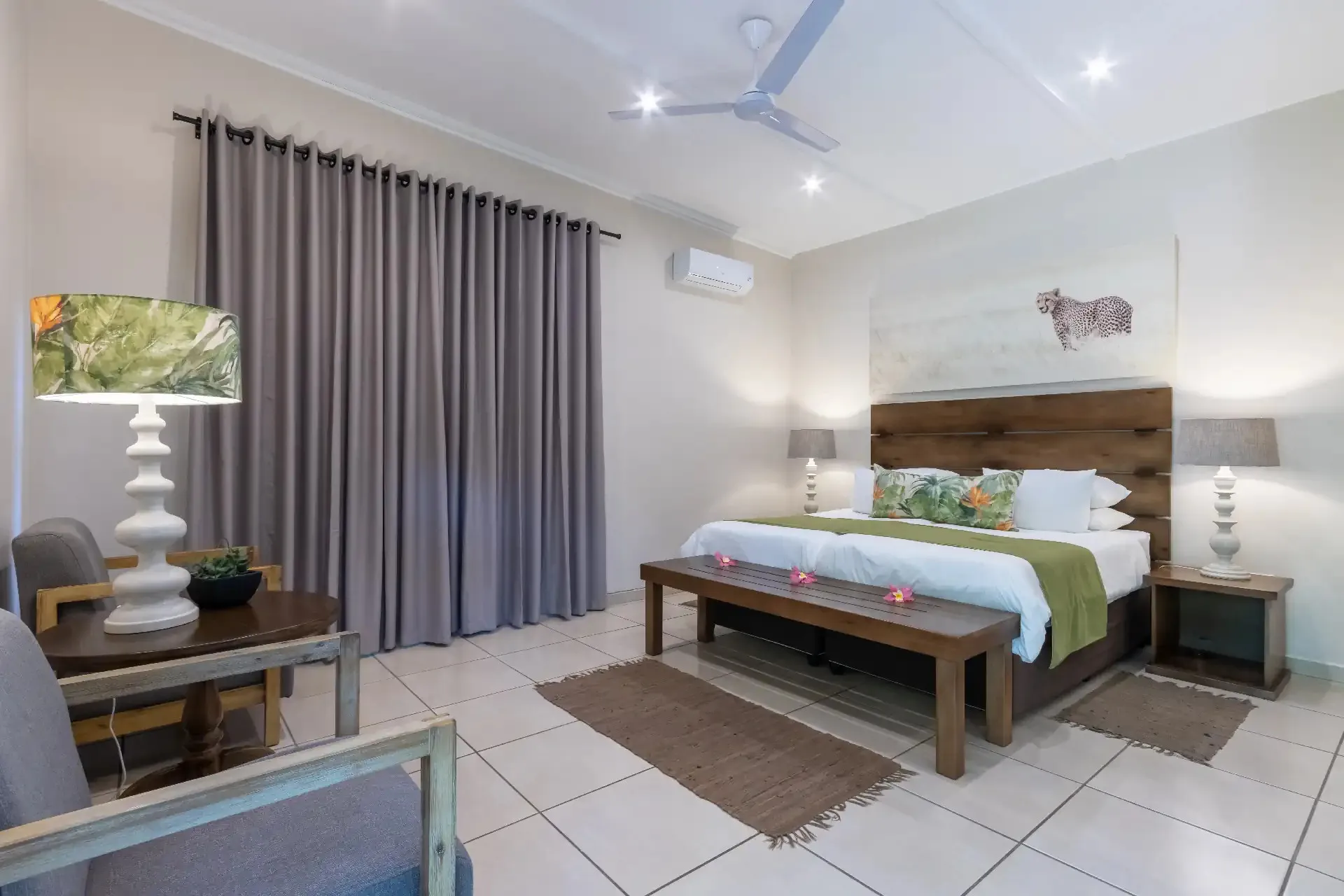 Modern bedroom with a large bed wooden headboard and bedside lamps