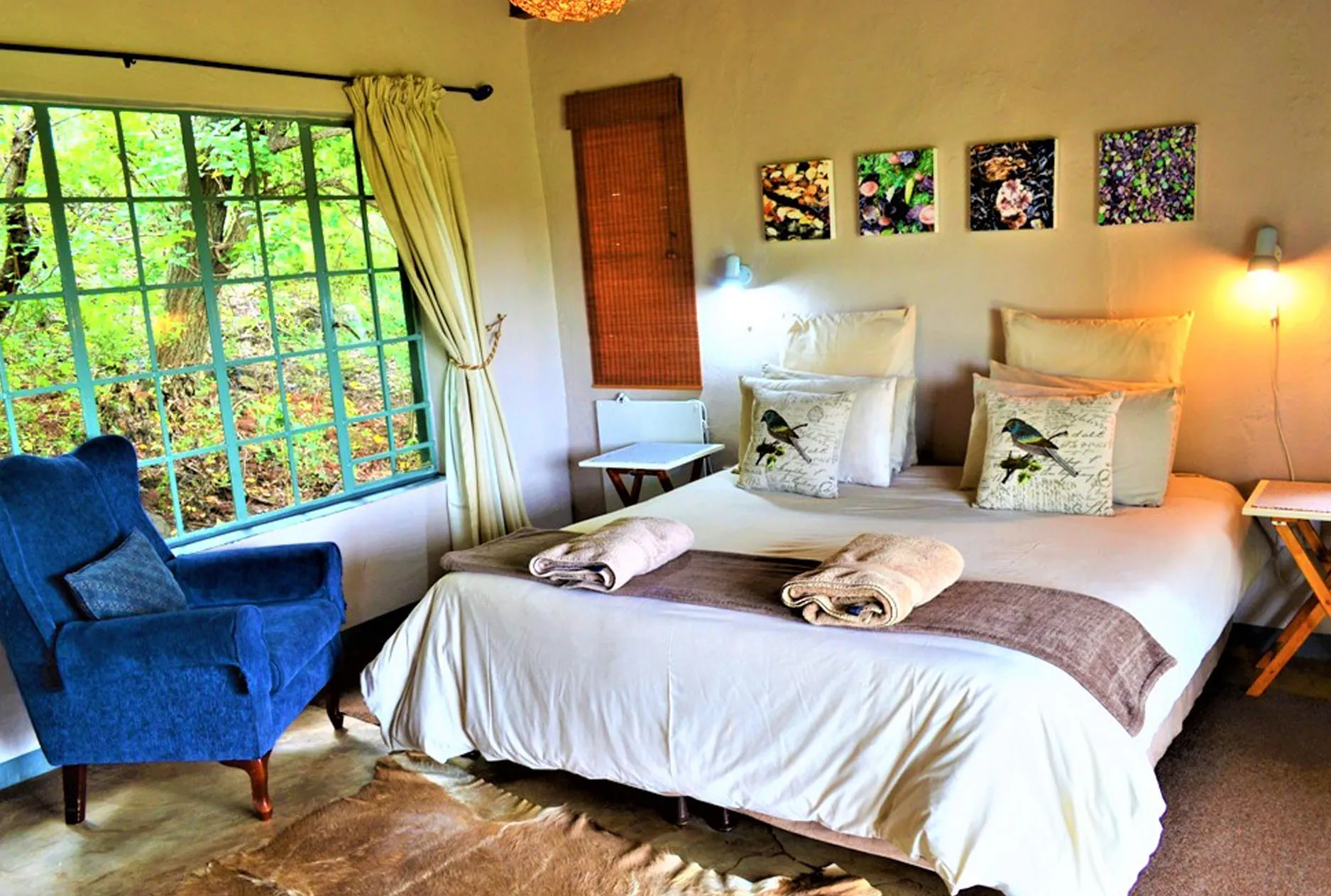 Cozy bedroom with a large bed blue armchair and naturethemed decor