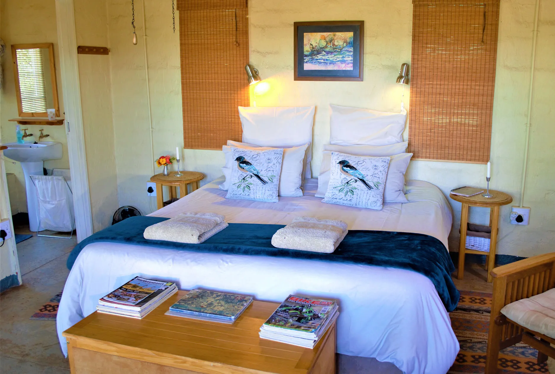 Cozy bedroom with a neatly made bed books and warm lighting