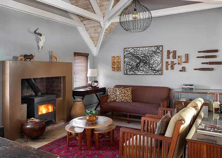 Cozy living room with a fireplace modern art and wooden furniture