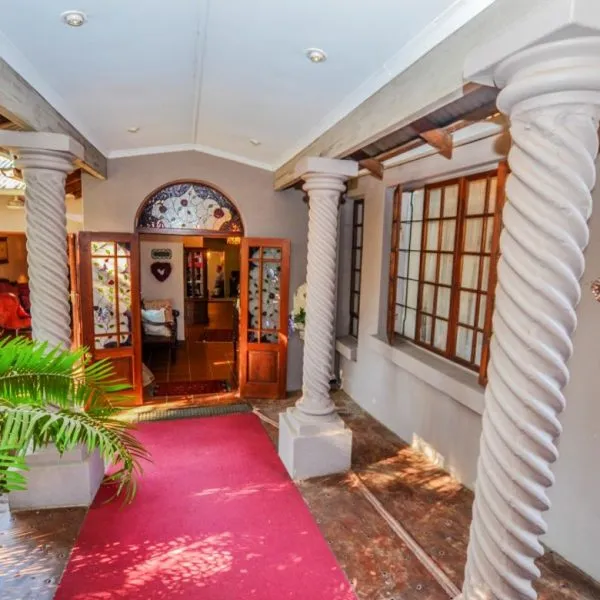 Entrance with red carpet wooden door and arched window in a home