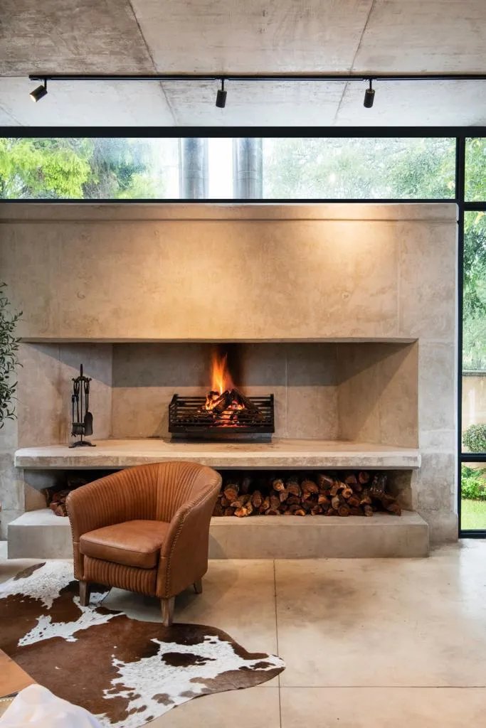 Modern living room with fireplace armchair and cowhide rug