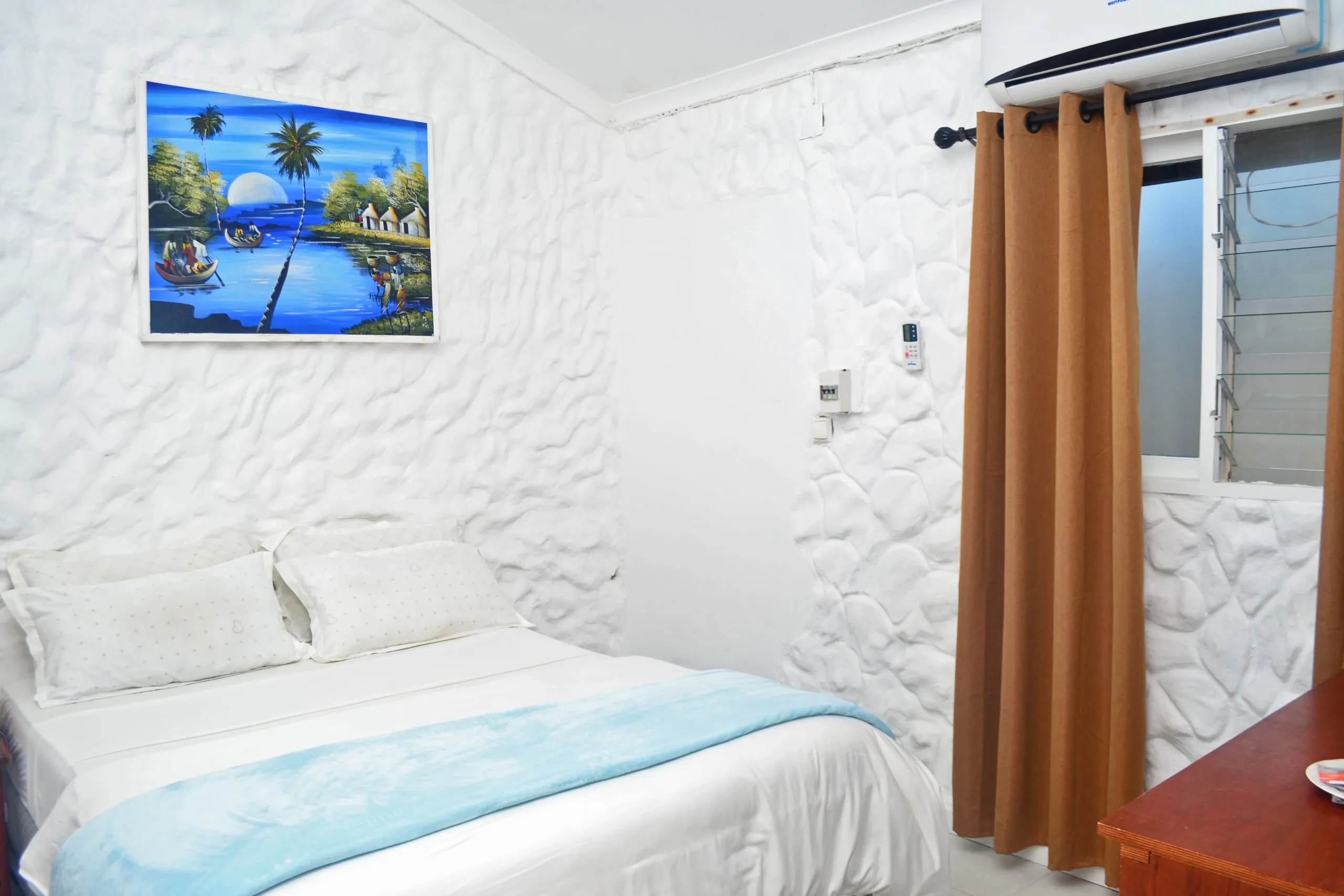 Cozy bedroom with white textured walls double bed painting and brown curtains