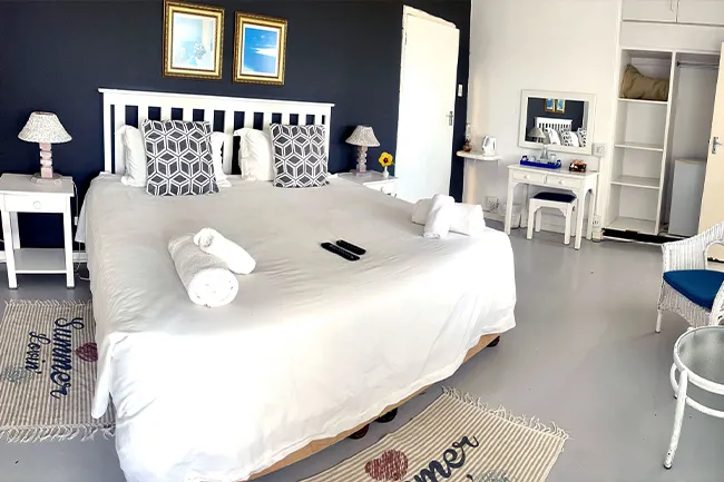 Bedroom with a large bed two bedside tables and a vanity table