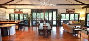 Openconcept living area with dining table kitchen and large windows