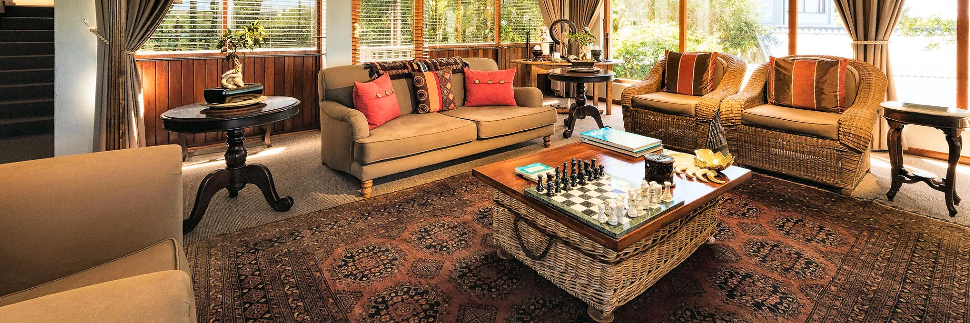 Cozy living room with sofas armchairs coffee table and large windows