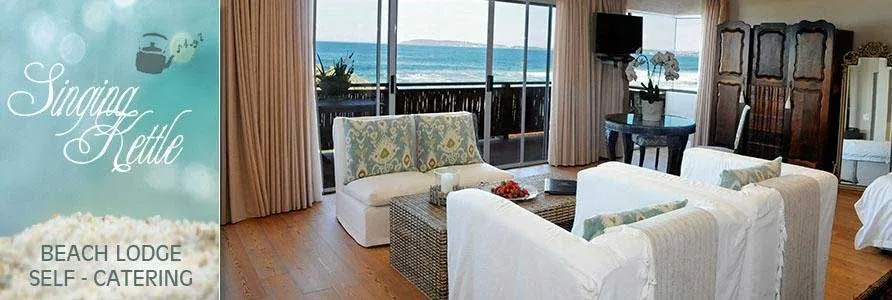 Beach lodge living room with ocean view white furniture and wooden flooring