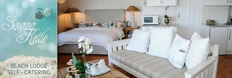 Cozy bedroom with white furniture sofa and kitchenette in a beach lodge