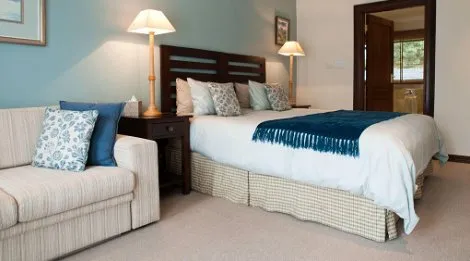 Cozy bedroom with a large bed sofa and bedside lamps