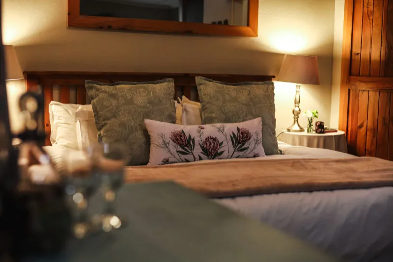 Cozy bedroom with a neatly made bed and bedside lamp