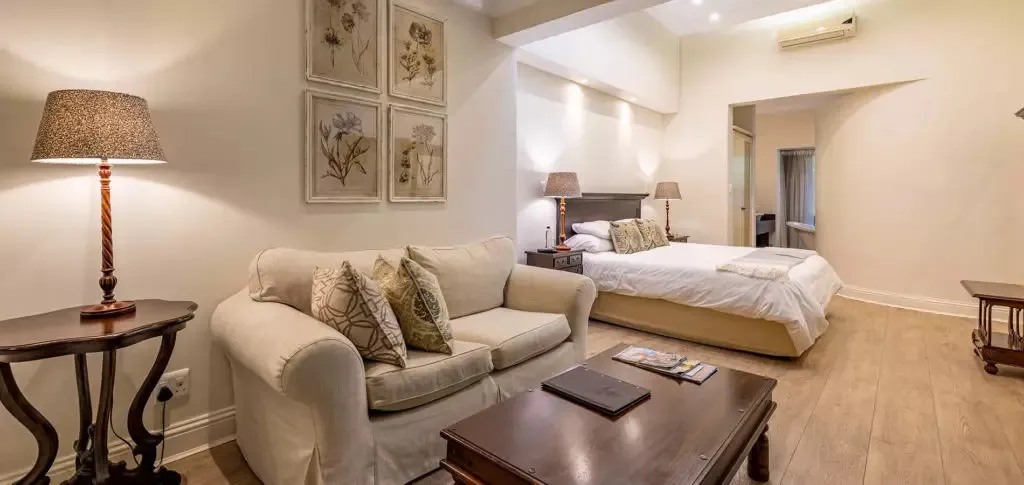 Cozy living room with sofa coffee table and adjacent bedroom with bed