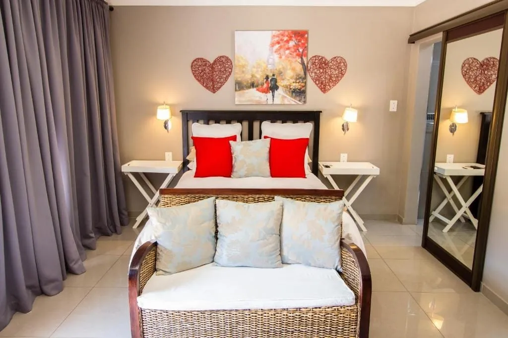 Cozy bedroom with a bed sofa and heartshaped wall decorations