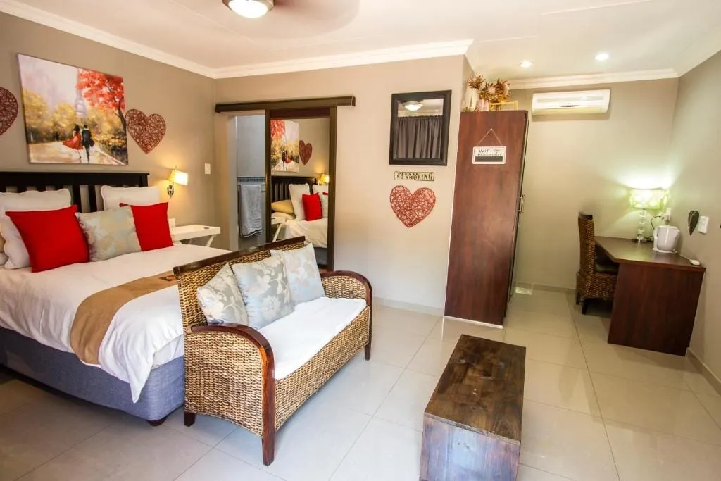 Cozy bedroom with a bed sofa desk and wooden furniture