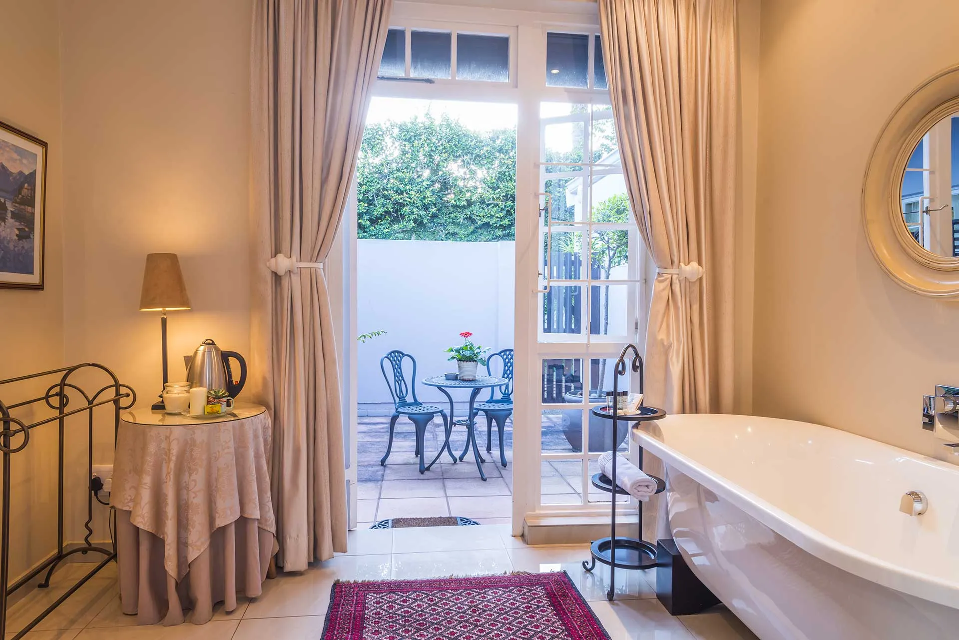 Elegant bathroom with bathtub open door to patio and soft lighting