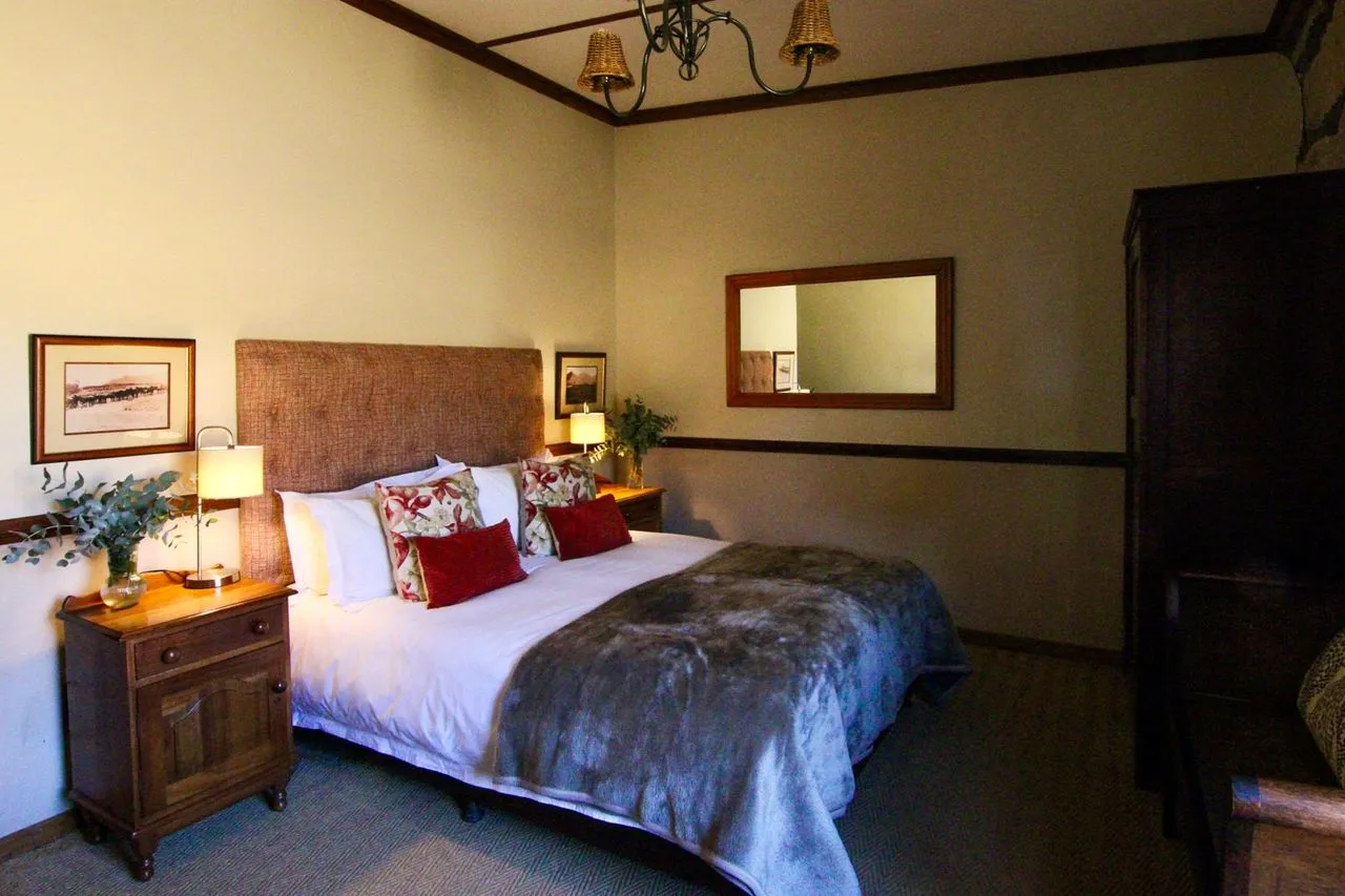 Cozy bedroom with a large bed wooden furniture and warm lighting