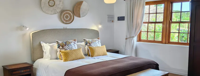 Cozy bedroom with a large bed pillows and a window with curtains