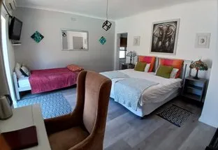 Cozy bedroom with two beds desk and wall art