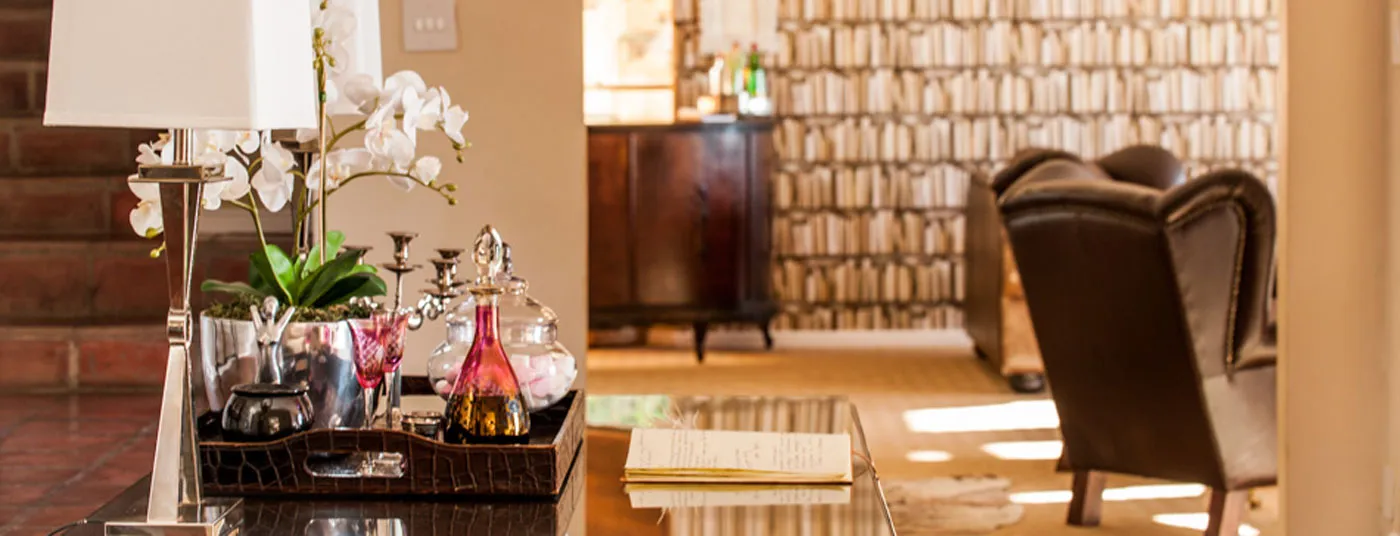 Living room with a wooden cabinet chairs and a table with decorative items