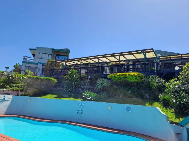 Modern house with pool garden and patio overlooking a hillside